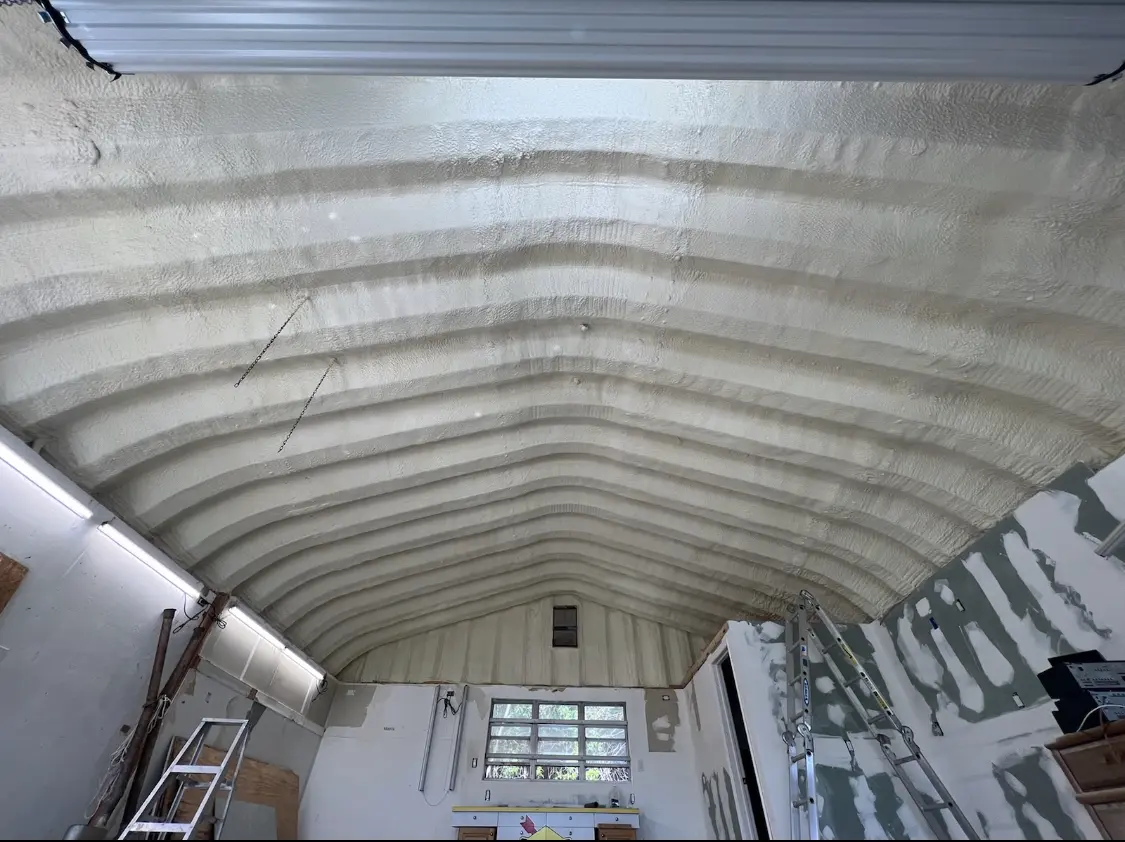 Spray polyurethane foam applied to the underside of a metal roof deck in Greenbelt